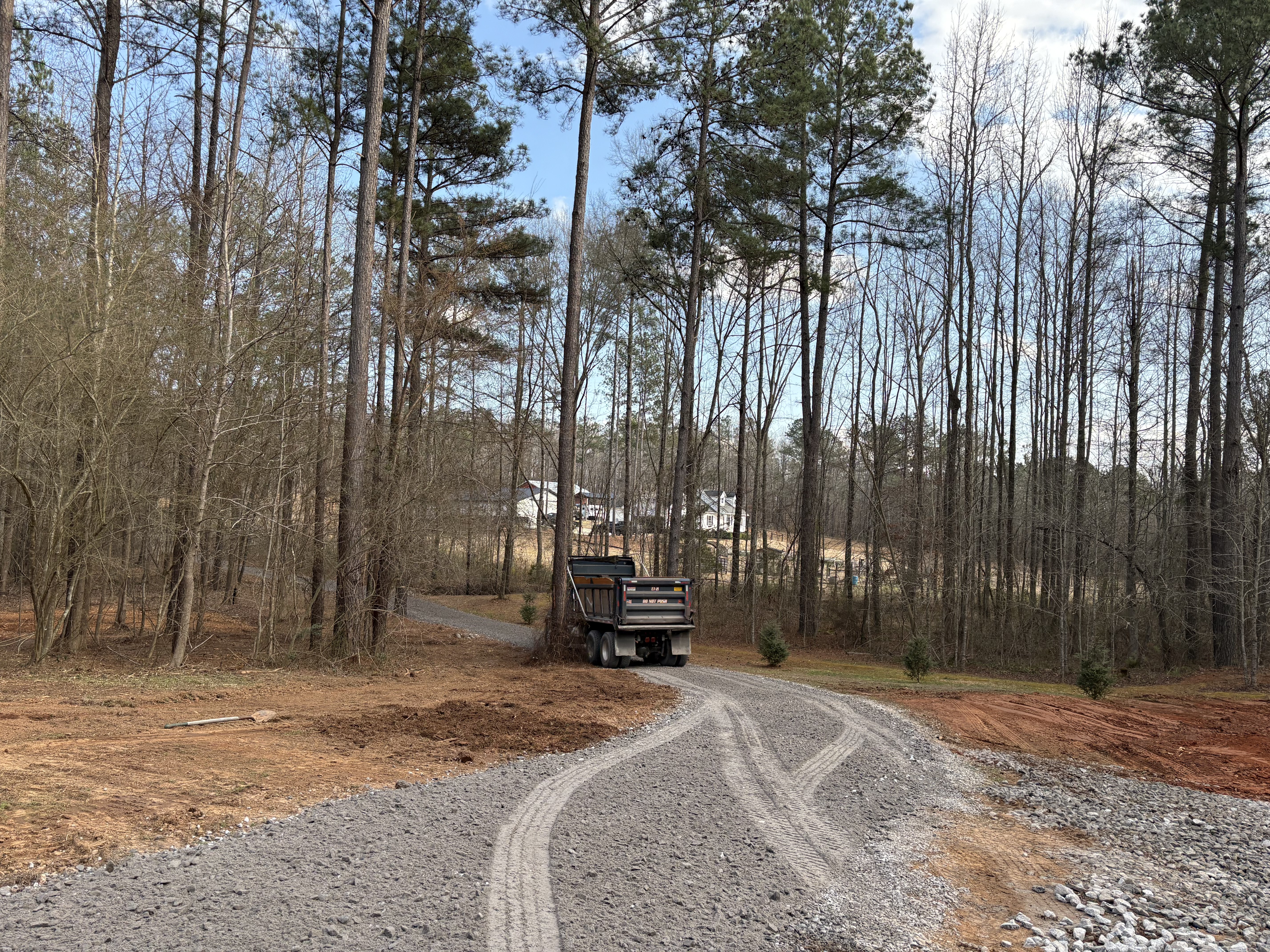 Property line clearing revealing open pasture after mulching